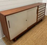 A Mid Century German sideboard with sliding doors, flanked by drawers to the right (H97cm W220cm