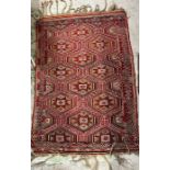 A red ground rug or wall hanging with yellow and browns 102cm x 146cm