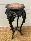 A Chinese stand table with marble octagonal top and carved frame AF (H92cm)