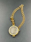 An 18ct gold ladies watch on a rolled gold bracelet (Approximate Total; weight 15.5g)
