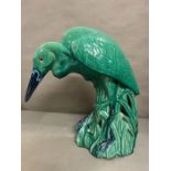 A glazed heron, on green grounds (Approximately 65cm High.