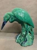 A glazed heron, on green grounds (Approximately 65cm High.