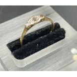 An antique diamond and gold ring on a platinum setting (Approximate Total Weight 1.4g) Size M