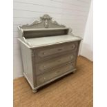 A French Louis style chest of drawers, the scrolling gallery back and shelf are sat upon a base of