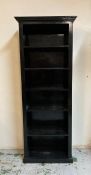 A black painted six shelf book case (H203cm W80cm D34cm)