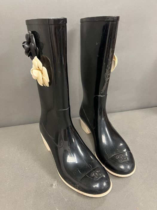 A pair of Chanel Camelia Rain boots