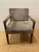 An art deco style easy chair upholstered in greys and browns