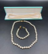 Pearl necklace with silver fastener and pearl necklace and bracelet set.