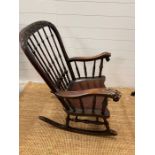A Windsor rocking chair with turned spindles and carved foo dogs handles (H96cm W68cm)