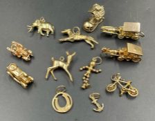 A selection of 9ct gold charms to include cars, horse and carriage and an elephant. 43.4g