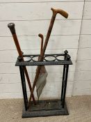 A cast iron stick stand with walking cane (H51cm W41cm D16cm)