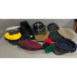 A collection of military caps and hats, various camps and regiments