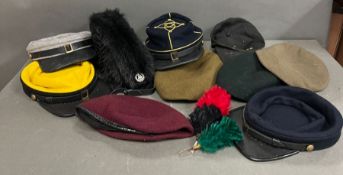 A collection of military caps and hats, various camps and regiments
