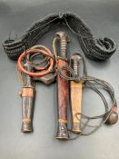 A selection of three African tribal knifes in sheaths along with two further tribal items.