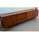 A Mid Century sideboard with three drawers, a two door cupboard and bar with drop down door (H75cm