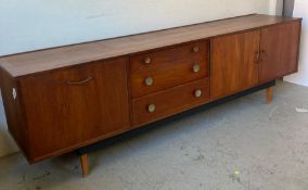 A Mid Century sideboard with three drawers, a two door cupboard and bar with drop down door (H75cm