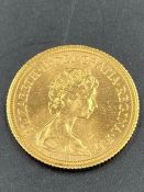 A 1980 Sovereign gold coin.