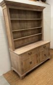 A light beech country house dresser, three adjustable shelves, sat on drawers and cupboard base (