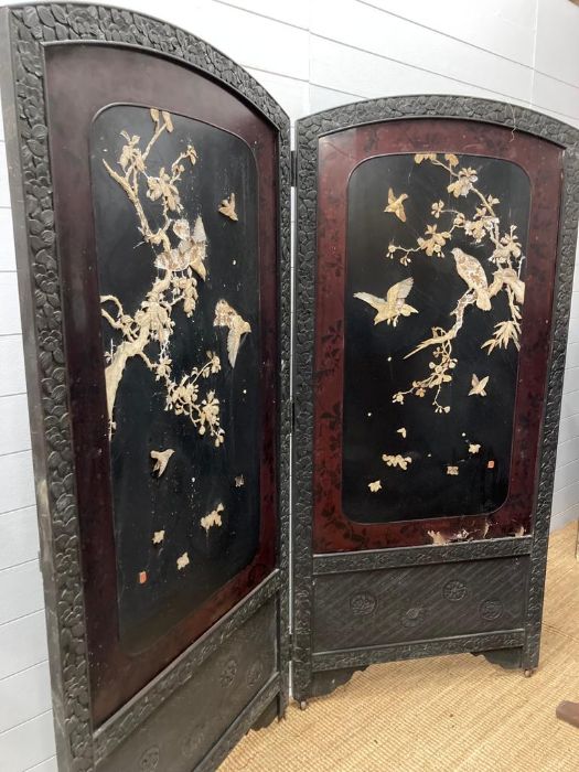 A late 19th century Japanese black laquered screen with mother of pearl and bone bird details.