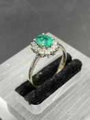 An emerald and diamond cluster ring on yellow gold setting. Size N, Weight 7.0g