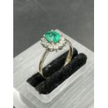 An emerald and diamond cluster ring on yellow gold setting. Size N, Weight 7.0g