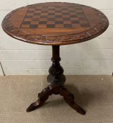 A Victorian style games table on carved centre support and three turned legs (H80cm Dia60cm)
