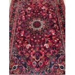 A Hamedan Persian style rug, red grounds 220cm x 140cm