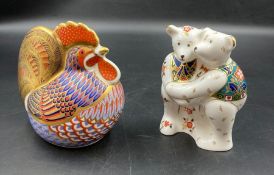 Two boxed Royal Crown Derby paperweights, Cockerel and Bear Hug, one with gold stopper.