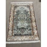 A silk rug, cream and green grounds possibly Turkish 200cm x 130cm