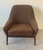 A Mid Century Parker Knoll arm chair upholstered in browns and blacks
