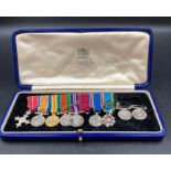 A miniature medal bar to include MBE, British War Medal, Victory Medal, Defence Medal War Medal