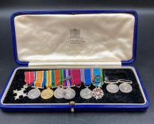 A miniature medal bar to include MBE, British War Medal, Victory Medal, Defence Medal War Medal