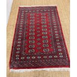 A Bokhara red rug 155cm x 98cm