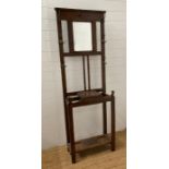 An oak hall stand with six hooks, central mirror and hinged storage to centre AF (H182cm W64cm
