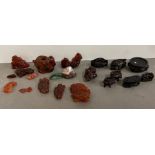 A collection of miniature carved figurines and stands, possibly amber