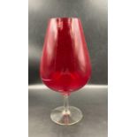 A large red glass brandy balloon height 34 cm