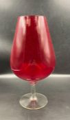 A large red glass brandy balloon height 34 cm