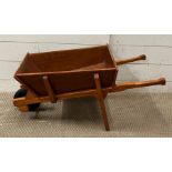 A vintage wooden children's wheelbarrow (H37cm W80cm D39cm)