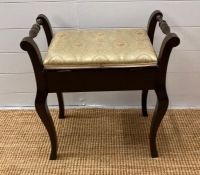 A mahogany upholstered piano stool on splayed legs with turned handles