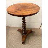 A circular side table on barley twist centre support, finish on a raised tri-form base (H70cm