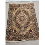 A Persian style rug with brown and cream grounds and centre medallion 200cm x 144cm