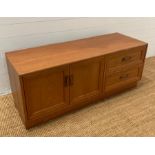 A Mid Century G-Plan media unit with two drawers and a two door cupboard (H54cm W131cm D46cm)