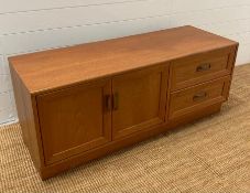 A Mid Century G-Plan media unit with two drawers and a two door cupboard (H54cm W131cm D46cm)