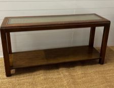 A console table with glass and woven top with a shelf under (H67cm W134cm D40cm)