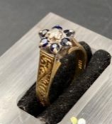 An 18ct gold ring with sapphires and diamonds in a daisy style. size L1/2 (Approx Weight 4.5g)