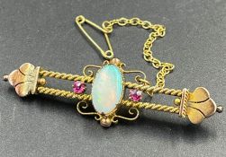 An Opal and ruby brooch in a gold setting AF