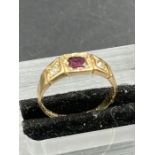 A 15ct gold ring with garnet and diamonds (Approximate Total Weight 2.6g) Size K