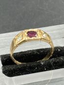 A 15ct gold ring with garnet and diamonds (Approximate Total Weight 2.6g) Size K