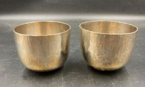 A pair of silver hammered tumblers, hallmarked for London 1970 and bearing makers mark PFT (