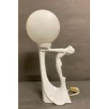 A white Art Deco style table lamp of a lady arching her back